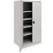 A light gray metal Tennsco storage cabinet with shelves.