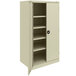 A beige Tennsco metal storage cabinet with shelves and solid doors.