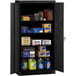 A black Tennsco standard storage cabinet with shelves full of items.