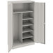 A light gray Tennsco metal storage cabinet with solid doors and shelves.