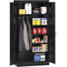 A black metal Tennsco storage cabinet with items on the shelves.