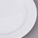 An Arcoroc white porcelain side plate with a white rim.