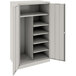 A light gray metal Tennsco storage cabinet with shelves.