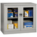 A light gray Tennsco storage cabinet with C-Thru doors.