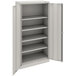 A light gray metal Tennsco storage cabinet with solid doors and shelves.