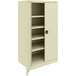 A white metal Tennsco storage cabinet with shelves and solid doors.