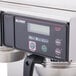 A close up of the Bunn Axiom coffee brewer with silver bowls.