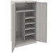 A light gray metal Tennsco combination cabinet with solid doors and shelves.