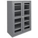 A dark gray metal Tennsco storage cabinet with C-Thru doors and shelves.