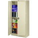 A Tennsco putty metal storage cabinet with solid doors open to reveal books inside.