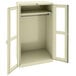 A white metal Tennsco wardrobe cabinet with open doors.
