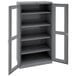 A dark gray metal Tennsco storage cabinet with open doors.