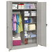 A grey metal Tennsco jumbo combination cabinet with solid doors and items on the shelves.