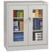 A light gray Tennsco storage cabinet with C-Thru doors.