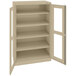 A tan metal Tennsco storage cabinet with open doors.