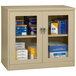 A Tennsco sand storage cabinet with C-Thru doors filled with blue and white boxes.