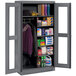 A dark gray metal Tennsco combination cabinet with open doors.