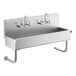 A Regency stainless steel wall-mounted hand sink with two faucets.