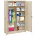 A Tennsco sand jumbo combination cabinet with solid doors filled with items on the shelves.