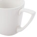 A close-up of a CAC Bone White Porcelain coffee cup with a handle.