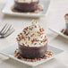 A plate of chocolate cupcakes with Mona Lisa Chocolate Crispearl sprinkles.