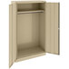 A tan metal Tennsco wardrobe cabinet with open solid doors.