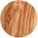 A close up of a wood surface on a round Enjay cake board with a brown finish.