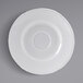 A Tuxton bright white saucer with a scalloped edge.
