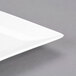 A CAC white porcelain dinner plate with a coupe shape and a small square cut out.