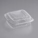 A clear plastic World Centric hinged container with a square lid.