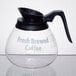 A Grindmaster glass coffee decanter with a black handle.