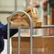 A worker using a Lavex steel utility cart to move boxes.