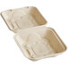 A white World Centric compostable fiber clamshell container with text on it.
