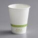 A white World Centric paper hot cup with green text.