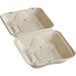 A white World Centric compostable fiber clamshell container with a black line.