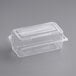 A clear plastic World Centric hinged clamshell container with a lid.