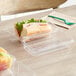 A sandwich in a World Centric clear plastic hinged clamshell container.