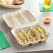 A white World Centric 3-compartment taco container with two tacos, tortillas, and salsa.