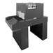 A large black Sealer Sales shrink tunnel machine with white buttons.
