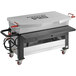 A large rectangular metal liquid propane seafood boiler cart with red handles and wheels.