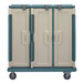A close-up of a Cambro meal delivery cart with a white door and blue trim.