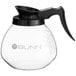 A Bunn glass coffee pot with a black handle.