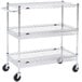 A Metro Super Erecta chrome three shelf utility cart with casters.