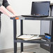 A Luxor black plastic utility cart with three shelves.
