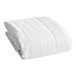 A folded CleanRest Pro white mattress encasement on a white surface.