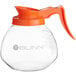A Bunn glass coffee pot with an orange handle.