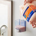 A person pouring Safeguard Professional liquid hand soap into a container.