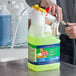 A person using a sprayer to clean a floor with Mr. Clean Professional Dilute2Go Finished Floor Cleaner.