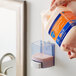 A person pouring Safeguard Professional liquid hand soap into a container.