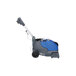 A blue and grey Powr-Flite walk behind cylindrical floor scrubber on wheels.